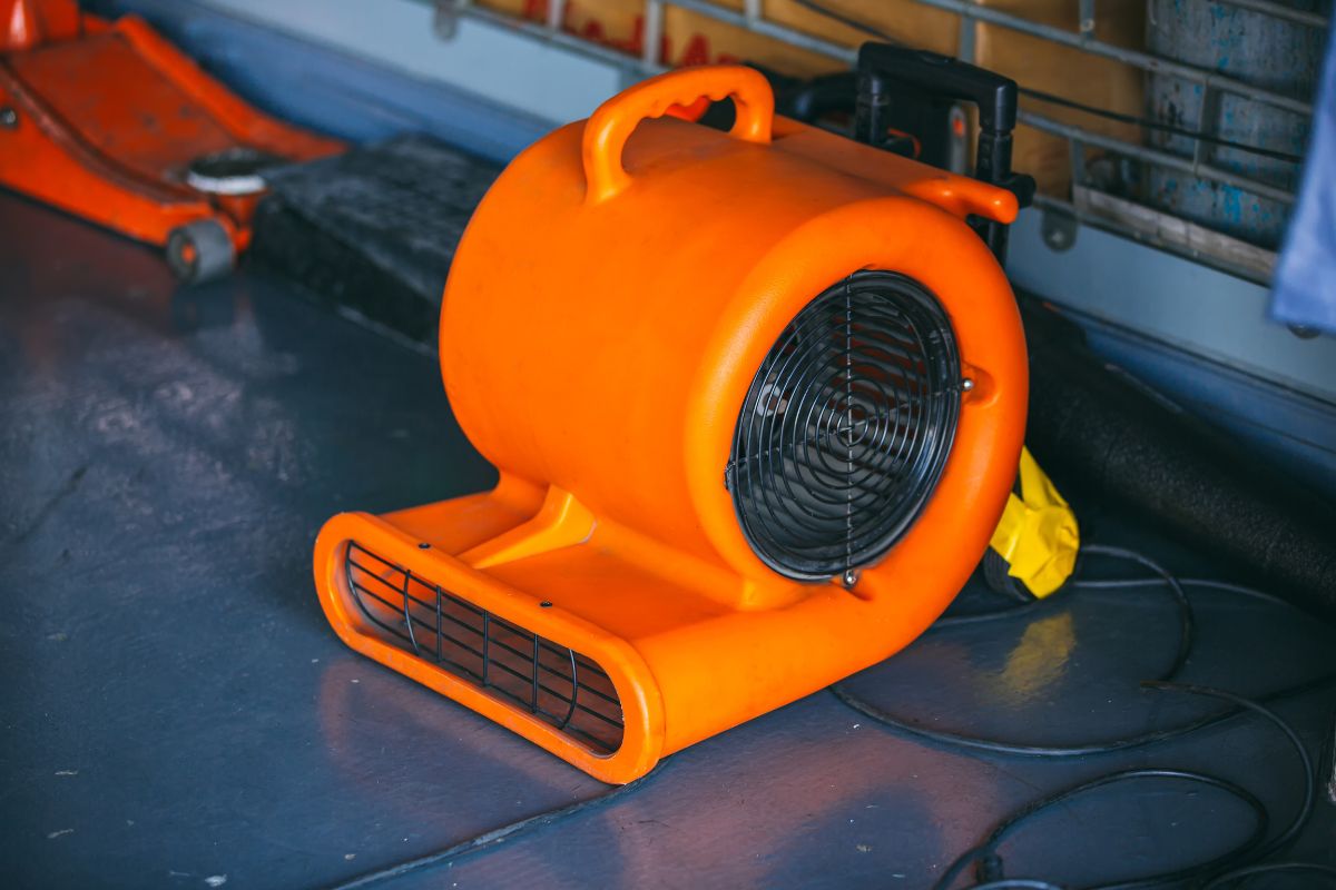 Restoration equipment and tools staged neatly in a hallway on a water damage jobsite, ready to run overnight.